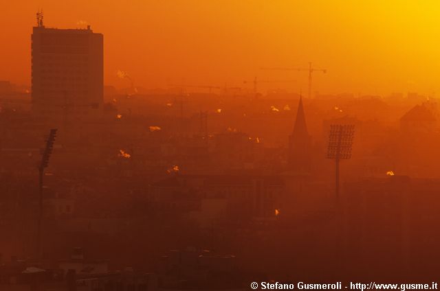  Tetti attorno a S.Marco, fumi caldaie e grattacielo Svizzero all'alba - click to next image